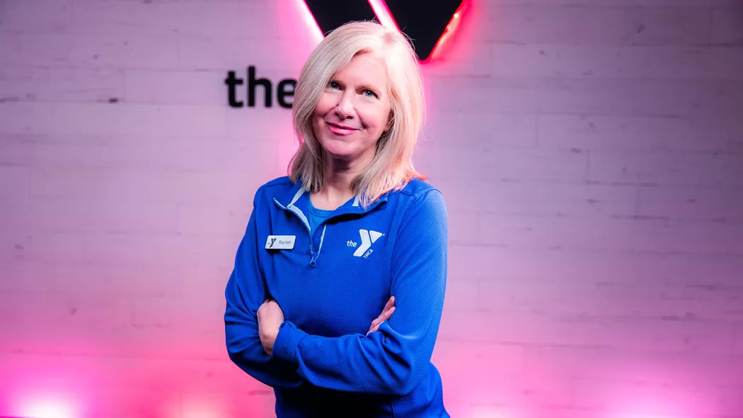 Maureen Peterson stands in front of the Virtual Studio at the Southdale YMCA