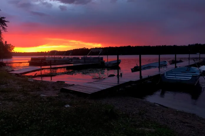 Sunset landscape of lakeshore with docked boats