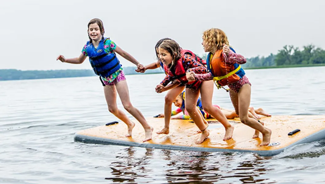 YMCA summer program participants jumping into water