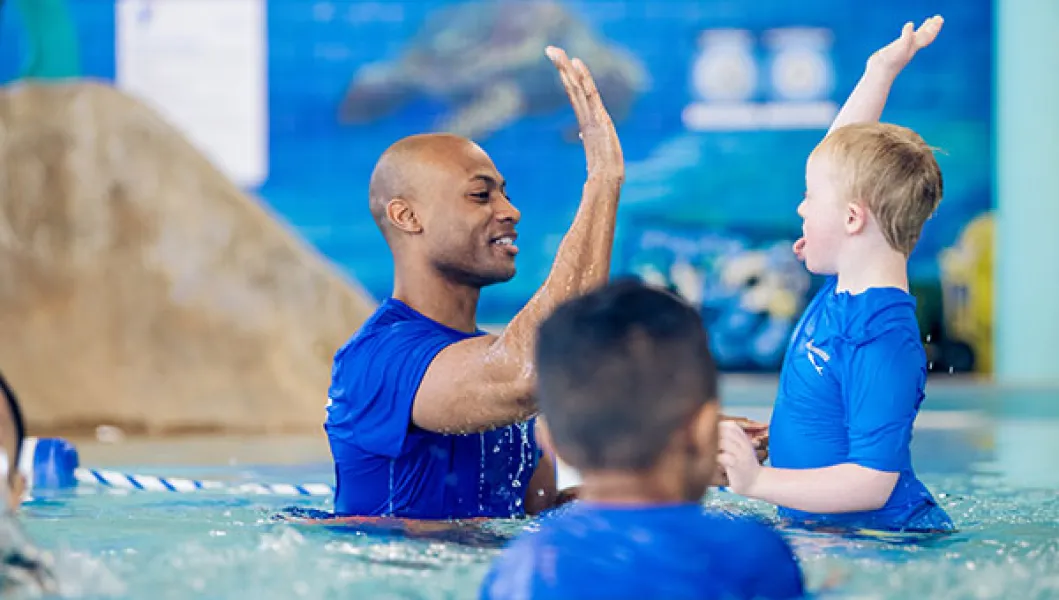YMCA swim instructor and students