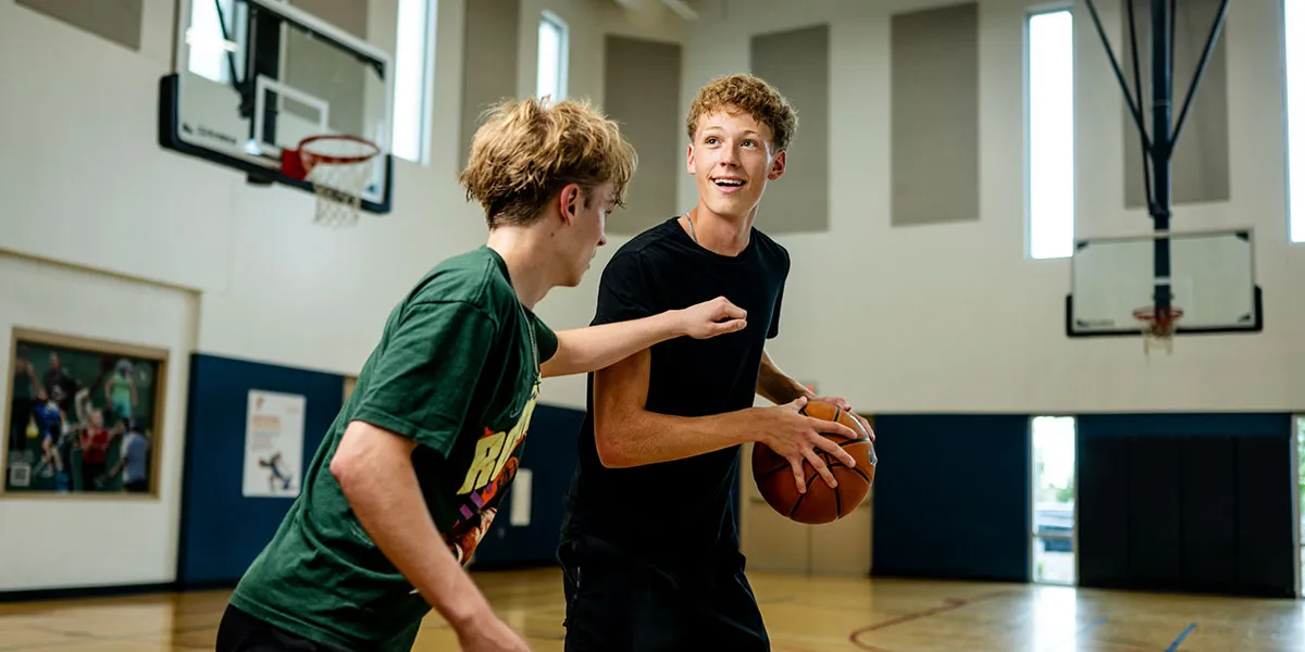 2 people playing basketball at the YMCA