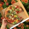 Pizza with flowers in the background