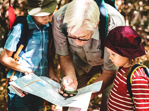 Man with two children looking at a map