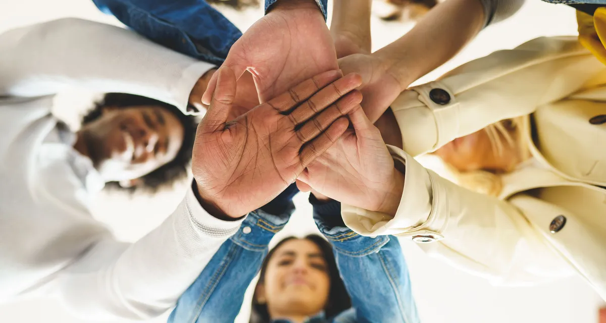 People huddling with their "hands in."