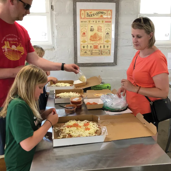 Family making pizza at Camp St. Croix
