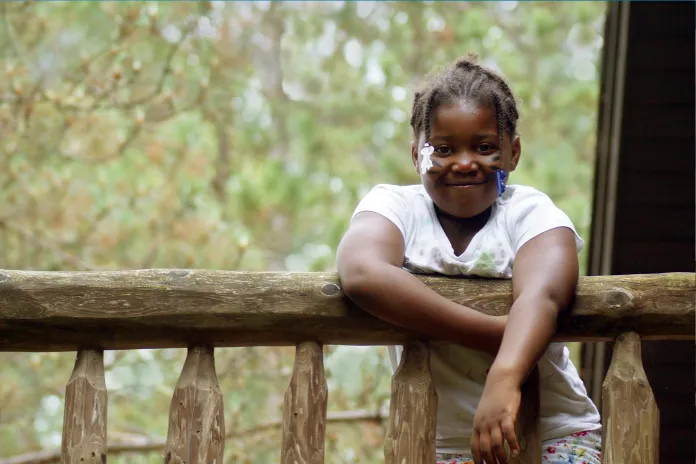 Smiling girl near cabin