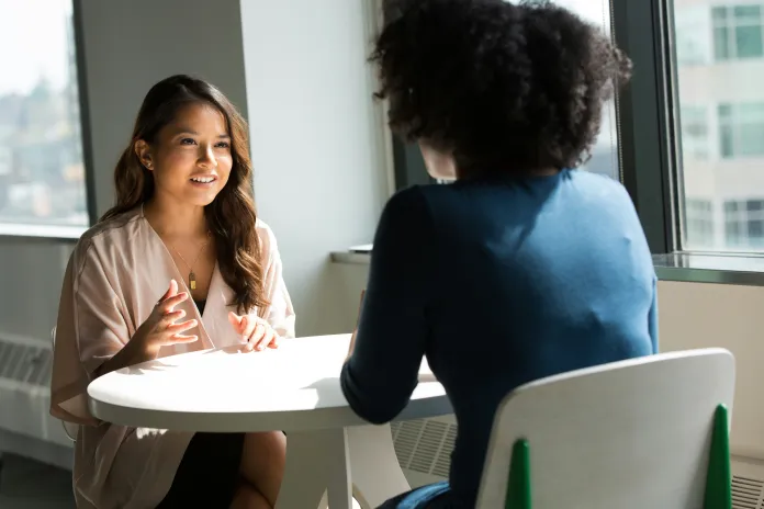 Two people conversing at a table