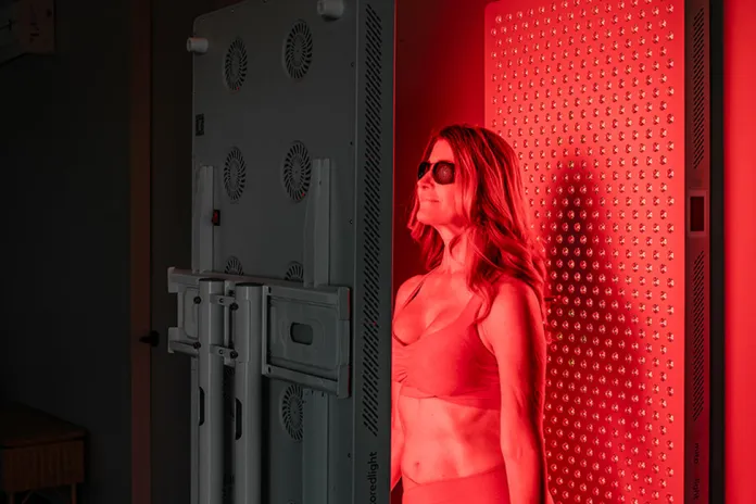 Woman in a Red Light Therapy booth