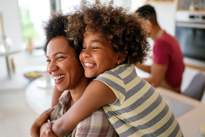 Mom and daughter smiling