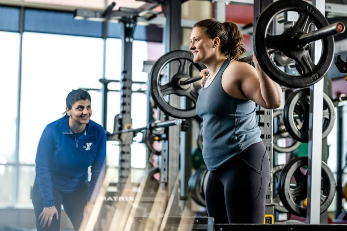 YMCA personal trainer instructing client