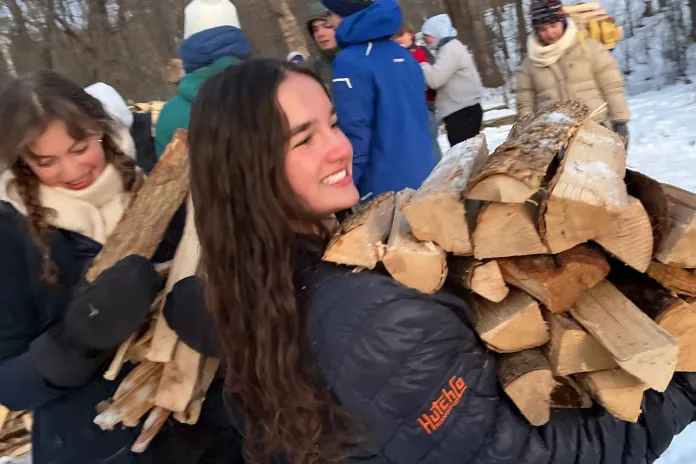Leaders Club members carrying wood during a service project.