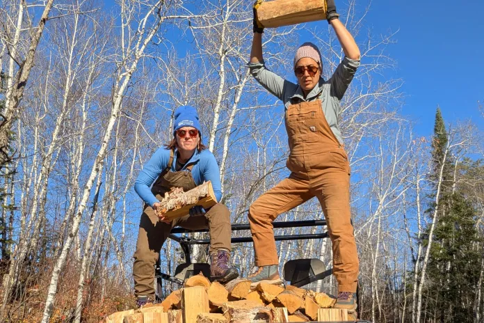 Karen and Sarah Rudolf stacking firewood.