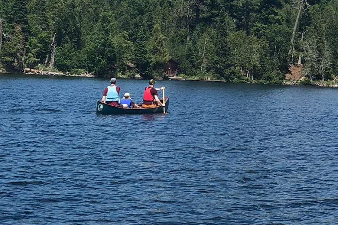 Camp Menogyn campers on a canoe