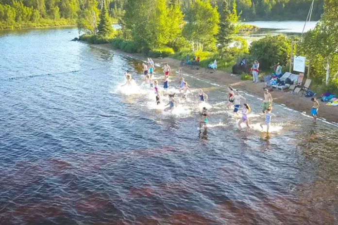 Campers swimming in Bear Island Lake at Camp Northern Lights