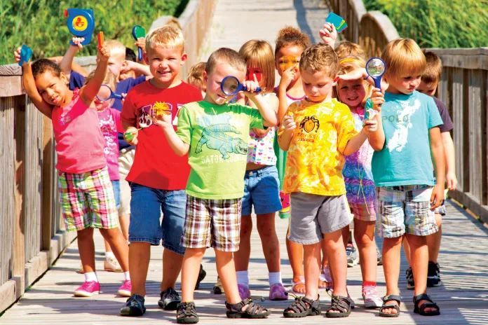 Preschool class with magnifying glasses