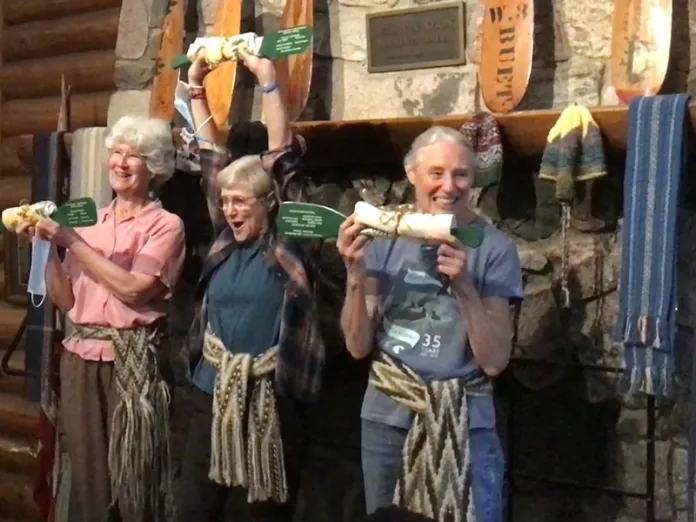 Keelin, Wendy, and Sally celebrate with campers in Widji’s dining hall.