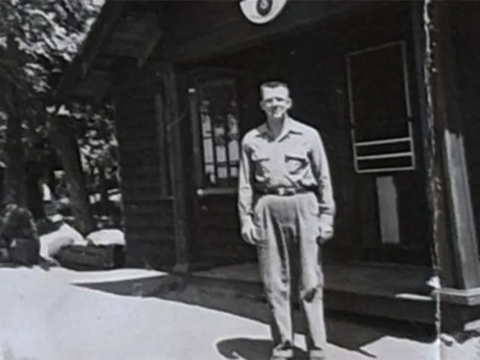 Ihduhapi staff member standing in front of the dining hall in the 1960s