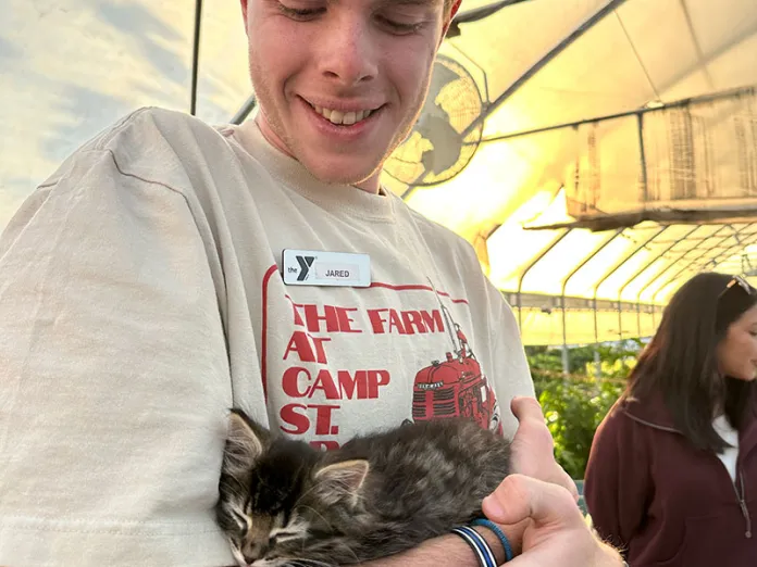 YMCA staff member holding a cat