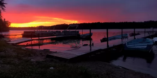 Sunset landscape of lakeshore with docked boats