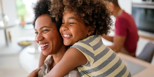 Mom and daughter smiling